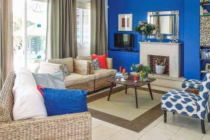a living room with a couch and a fireplace at Villa Elena Coral in Peyia