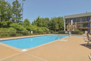 a person standing next to a swimming pool at Studio 6-Little Rock, AR - West in Little Rock