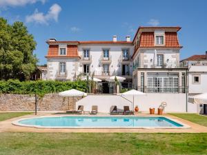 a large house with a swimming pool in front of it at Forrester Essence Douro Hotel - by Unlock Hotels in Alijó