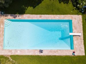 an overhead view of a large blue swimming pool at Casa con Piscina a Portoferraio in San Giovanni +18 photos