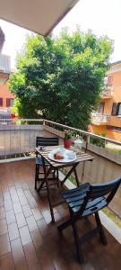 a table and chairs with a plate of food on a patio at La casa di Francesca in Tradate +9 photos