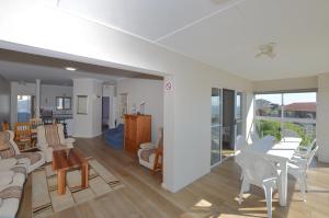 a living room and dining room with a table and chairs at Rabe's Rest in Yzerfontein