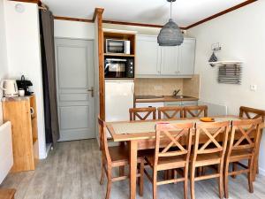 a kitchen with a table and chairs in a kitchen at DATCHA Joséphine Immobilier in La Salle Les Alpes