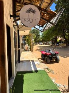 a sign on the side of a building with a green lawn at Principal Jeri in Jericoacoara