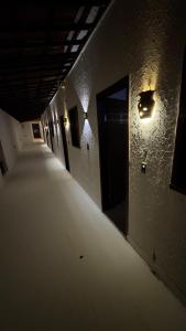 an empty hallway in a building with a light on the wall at Principal Jeri in Jericoacoara