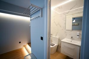 a bathroom with a toilet and a sink at Family Suite by Zeussuites in Athens