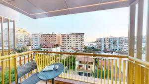 a balcony with a table and chairs and some buildings at Harbour Boutique Hotel in Shëngjin