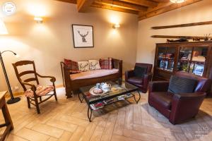 un salon avec des chaises, un canapé et une table dans l'établissement Gîte et chambres d'hôtes "La Tourtette" 12 pers, à Saint-Étienne-en-Dévoluy