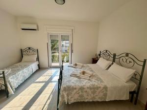 a bedroom with two beds and a window at Pollino Flower Park in Viggianello