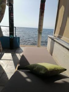 a green pillow sitting on a box on a boat at Amfialos in Skala Kallirakhis +28 photos