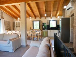a living room with couches and a kitchen and dining room at Mas Ca la Rossa in Girona