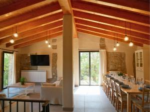 a dining room with a long table and chairs at Mas Ca la Rossa in Girona