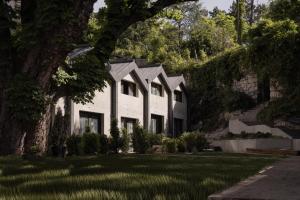 a white house with a tree and a yard at La Maison des Ducs in Chambéry