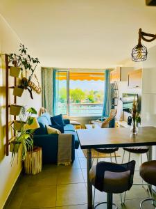a living room with a blue couch and a table at La Lagune in Le Grau-du-Roi