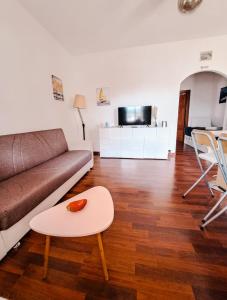 a living room with a couch and a table at The Shell in Vallecrosia