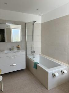 a white bathroom with a tub and a sink at B5 Villa Sueños in Santo Tomás +12 photos