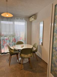 a dining room with a table and chairs at Apartments Kruno in Međugorje +26 photos