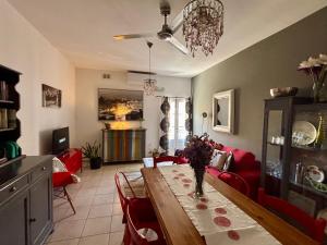 a living room with a table and red chairs at Simons Apartments minutes away from Balluta Bay and St Julians in Sliema