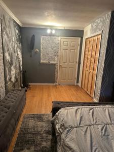 a living room with a couch and a door at Your Home away from Home ! UNIT 2- 1st floor in Baychester