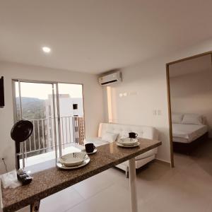 a room with a table and a bed and a mirror at Aviva Sierra 1804 in Santa Marta