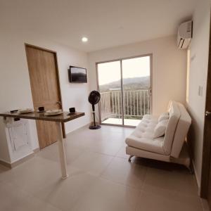a living room with a desk and a chair and a window at Aviva Sierra 1804 in Santa Marta +27 photos