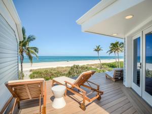 a porch with chairs and a view of the beach at Sandrift Villa in Captiva