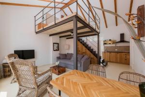 a living room with a table and chairs and a staircase at Apartments Argemonia in Mali Lošinj