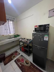 a kitchen with a refrigerator and a counter with donuts at Nest Haven in Nairobi