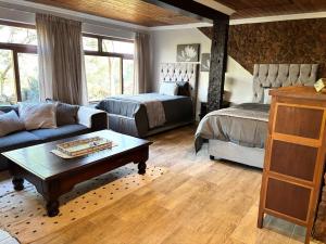 a living room with a couch and a bed at Casa Madeira 1 in Gillitts-Emberton