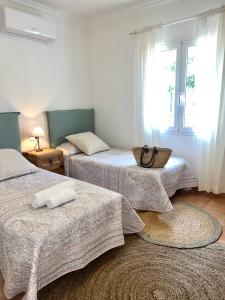 a room with three beds and a window at Quite villa with private pool in Binibeca in Binibeca +33 photos