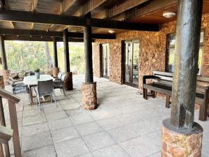 an outdoor patio with a table and a bench at Casa Madeira 1 in Gillitts-Emberton