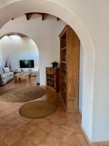 a living room with an archway with a couch and a tv at Quite villa with private pool in Binibeca in Binibeca