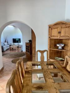 a wooden table and chairs in a living room at Quite villa with private pool in Binibeca in Binibeca