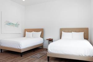 two beds sitting next to each other in a bedroom at Manhattan by Pristine Properties Vacation Rentals in Port Saint Joe