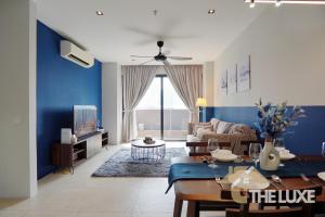 a living room with a couch and a table at Lumi Tropicana By The Luxe in Petaling Jaya