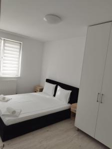 Ένα ή περισσότερα κρεβάτια σε δωμάτιο στο AME Home Apartament