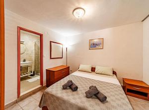 a bedroom with a bed with two pillows on it at Holiday Home Island Gem in Korčula