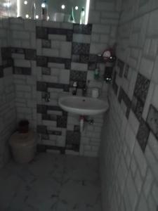 a bathroom with a sink and a toilet at Cozy Studio Apartment in Quatre Bornes