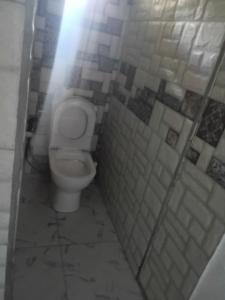 a bathroom with a toilet in a stall at Cozy Studio Apartment in Quatre Bornes