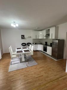 a kitchen with white cabinets and a table and chairs at Villa Pliva Oasis in Jezero