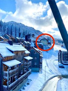 a town with a red sign in the snow at Byt na svahu Sonnenalpe Nassfeld in Hermagor