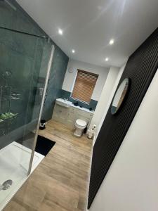 a bathroom with a shower and a toilet at Marine Cottage 1 - With Private Hot Tub in Newbiggin-by-the-Sea