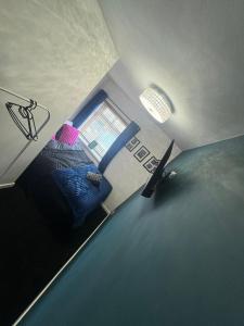 a small bedroom with a bed and a window at Marine Cottage 1 - With Private Hot Tub in Newbiggin-by-the-Sea