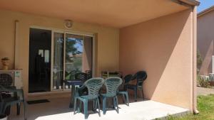 a group of chairs sitting around a table on a patio at Casa di u sole in Santa-Maria-Poggio