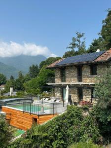 a house with a swimming pool in front of a building at Mergozzo Beach in Mergozzo