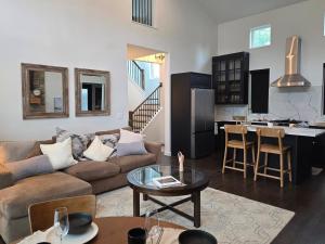a living room with a couch and a table at McHenry Riverside Retreat Comfort in McHenry