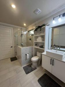 a bathroom with a toilet and a sink and a shower at Cozy Cottage Retreat in Nature in Cedar Creek +16 photos