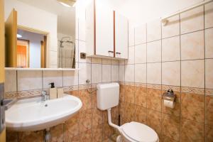 a bathroom with a white toilet and a sink at Apartments Hari in Supetarska Draga +51 photos