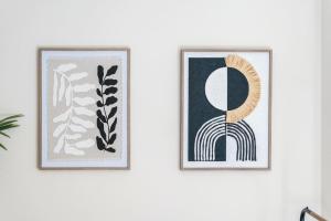 two framed prints on a white wall at Spacious 3-Bed Flat, Sleeps 7, Ideal for Families, Central Location, High-Speed Internet in Leicester