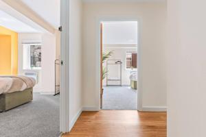 a bedroom with a bed and a door leading to a bathroom at Spacious 3-Bed Flat, Sleeps 7, Ideal for Families, Central Location, High-Speed Internet in Leicester +38 photos